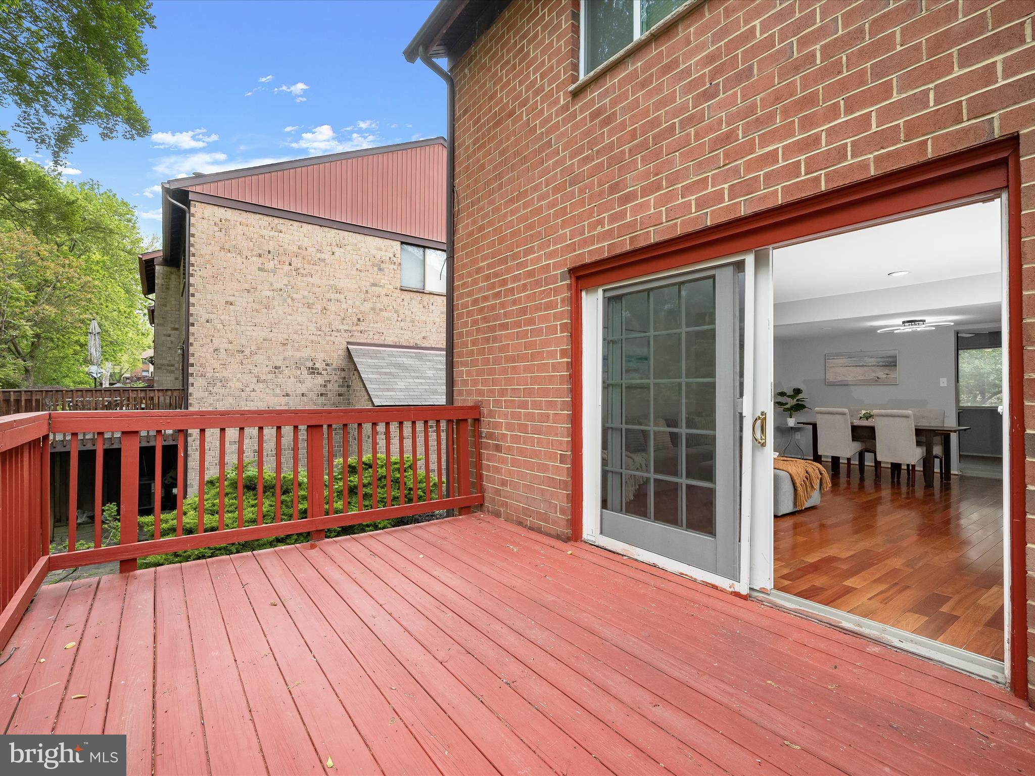 7106 Winter Rose Path Columbia, MD 21045 - Photo 40 of 50 a view of a balcony with wooden floor and floor to ceiling window