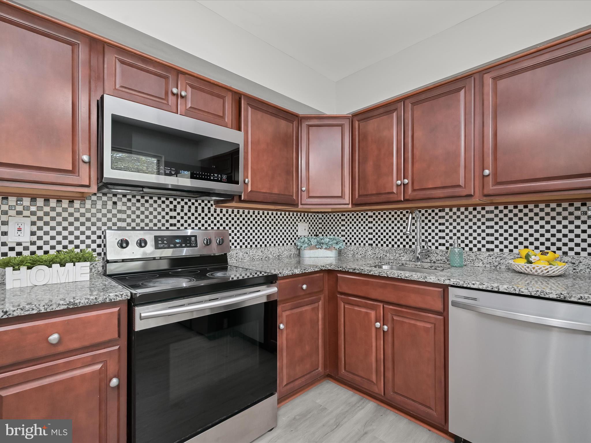 7106 Winter Rose Path Columbia, MD 21045 - Photo 9 of 50 a kitchen with a sink stove and cabinets