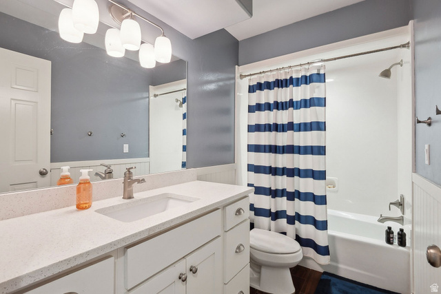 550 Pine Canyon Road Midway, UT 84049 - Photo 21 of 44 Bathroom featuring a single vanity with a solid surface countertop, white cabinetry, a built-in tub/shower combination, and dark wood-finish flooring