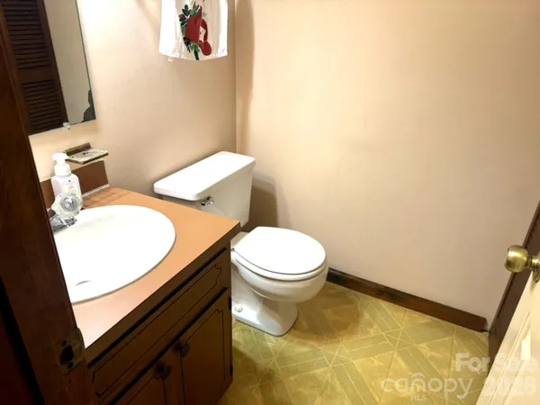 a white toilet sitting next to a sink