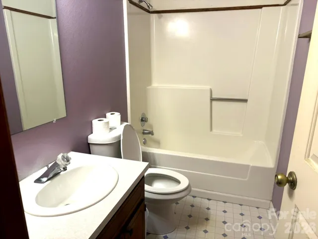 a bathroom with a sink a toilet and shower curtain