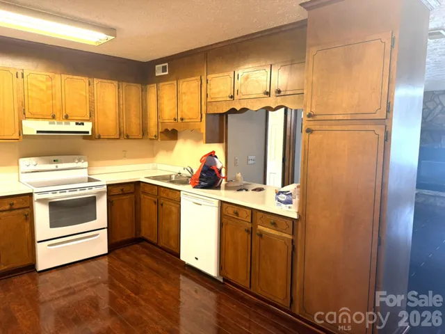 a kitchen with a refrigerator sink and cabinets
