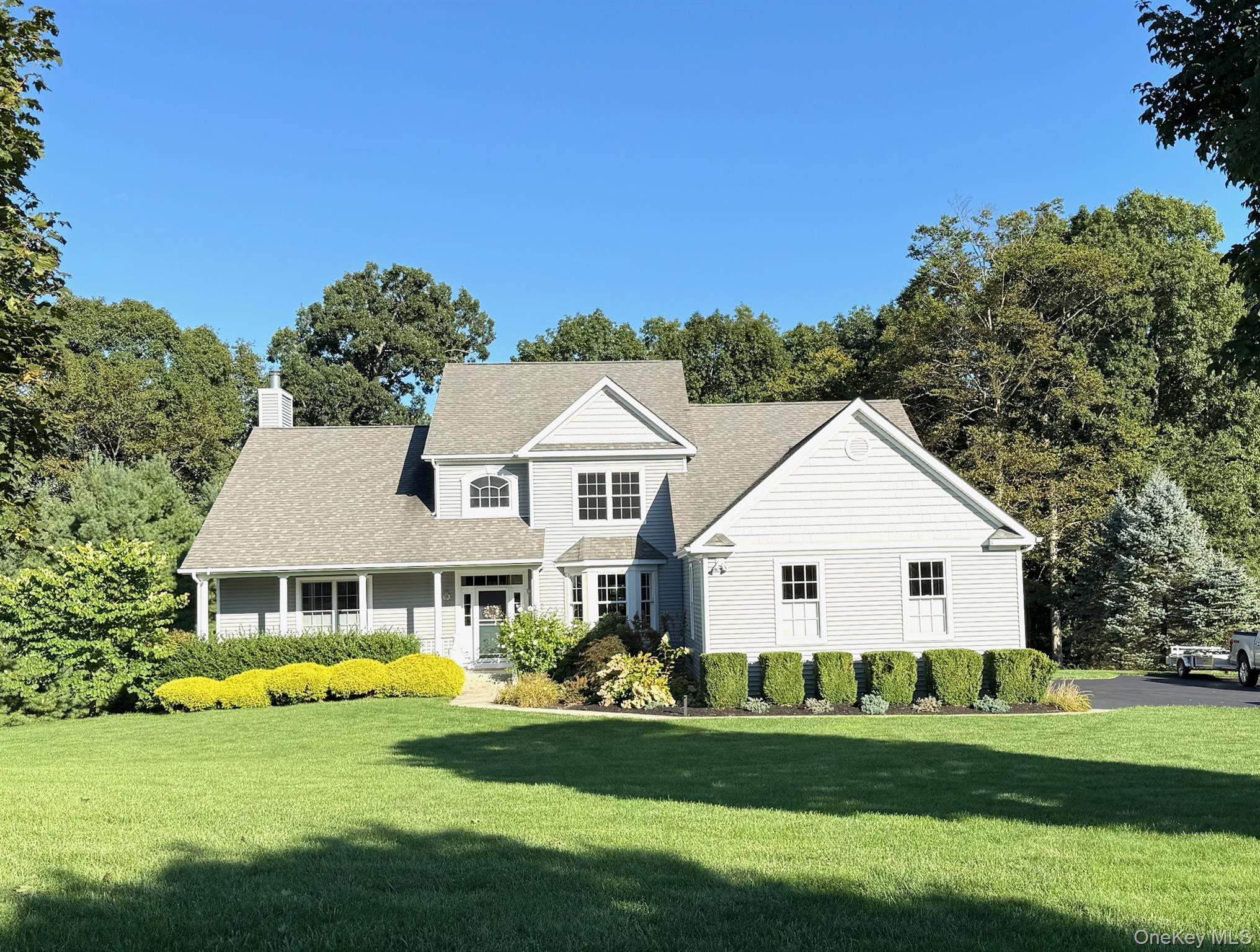 16 Ballymeade Road Hopewell Junction, NY 12533 - Photo 1 of 1 View of front of house with a front yard, a chimney, a shingled roof, and covered porch