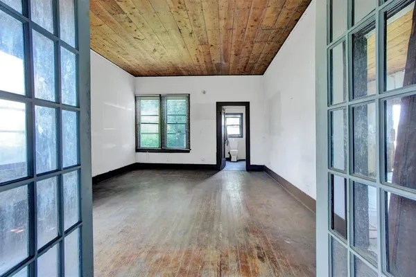 a view of an empty room with windows