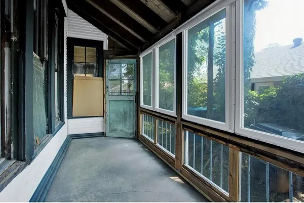 a view of a porch with wooden floor and outdoor space