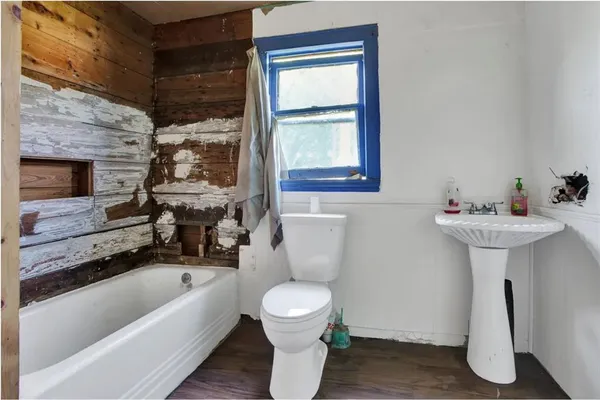 a bathroom with a sink a toilet and bathtub