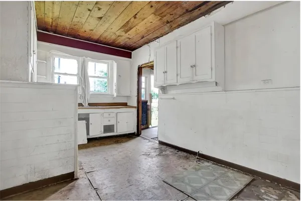 a view of a kitchen with white cabinets and a sink