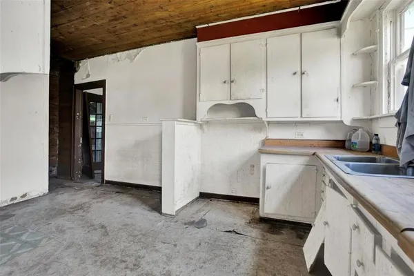 a kitchen with a sink a stove and cabinets