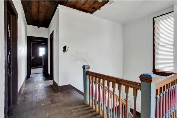 a view of a hallway with wooden floor and entryway