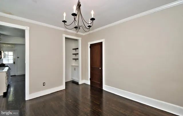 a living room with wooden floor and a fireplace