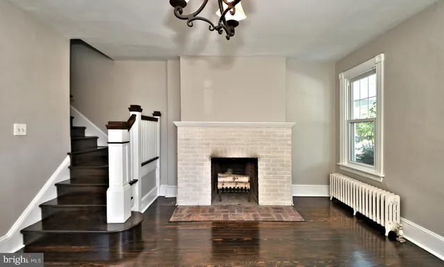 an empty room with wooden floor and a window