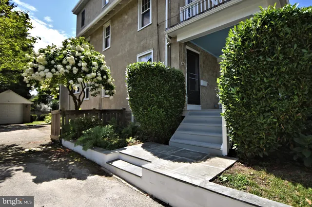 a view of a house with potted plants