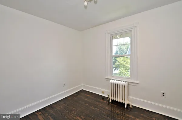 an empty room with fan and windows
