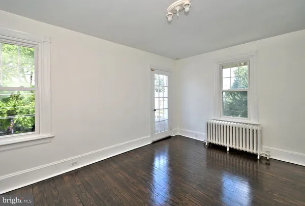 a view of a small space with wooden floor and a bathroom