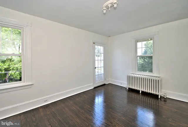 a view of a small space with wooden floor and a bathroom