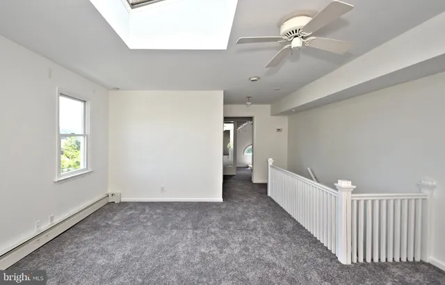 a pathway of a house with wooden fence