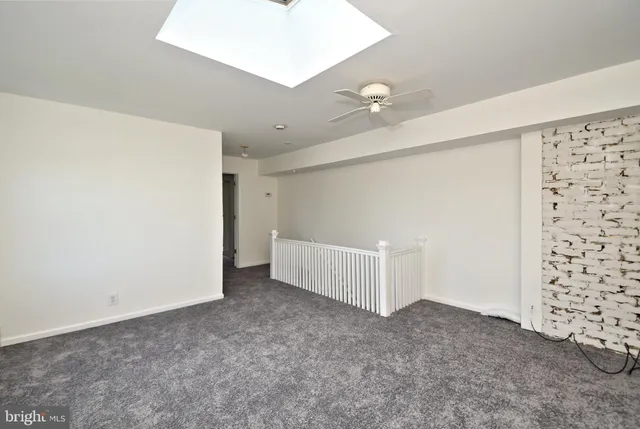 a front view of a house with a yard and a garden