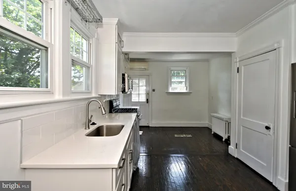 a kitchen with stainless steel appliances a stove microwave and cabinets