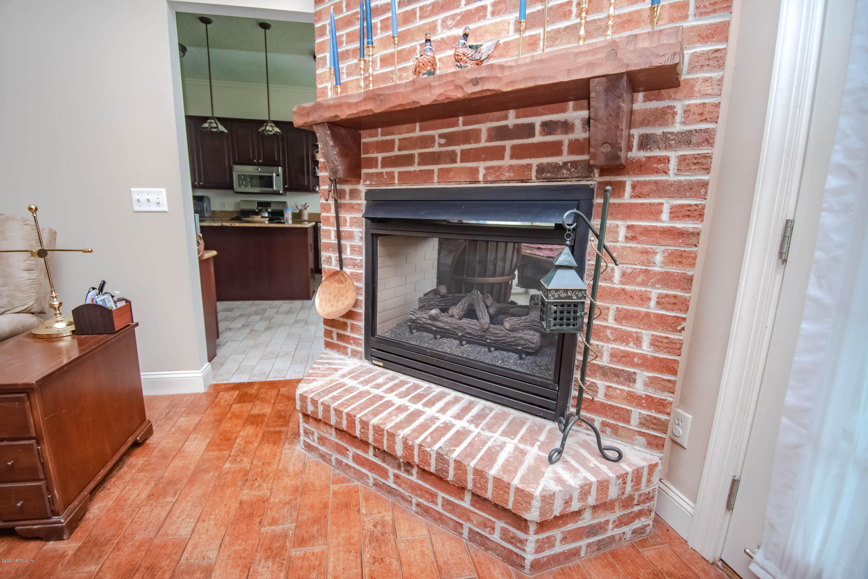 8219 Mud Lake Road Macclenny, FL 32063 - Photo 20 of 63 a living room with furniture and a fireplace