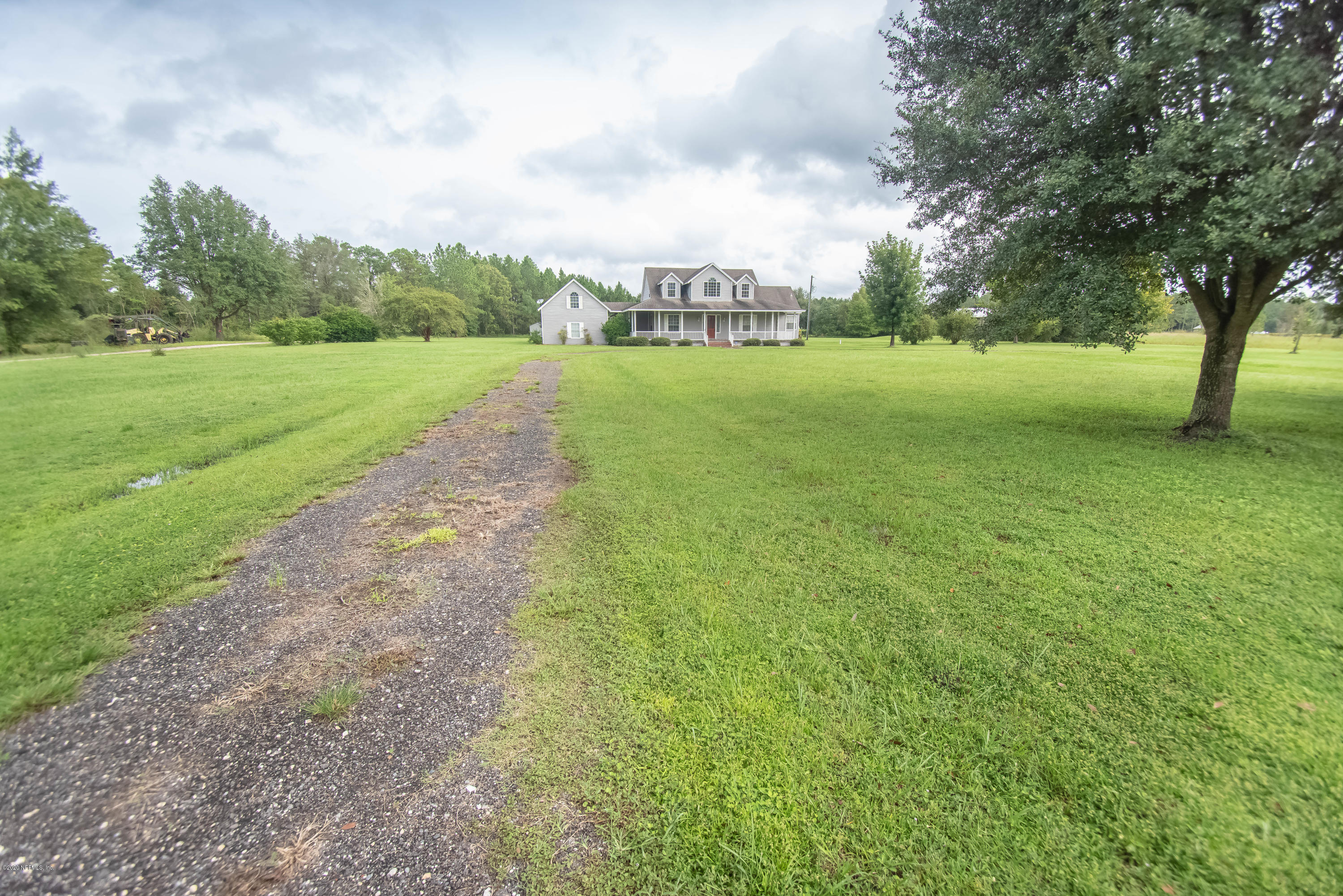 8219 Mud Lake Road Macclenny, FL 32063 - Photo 2 of 63 a view of a grassy field with trees around