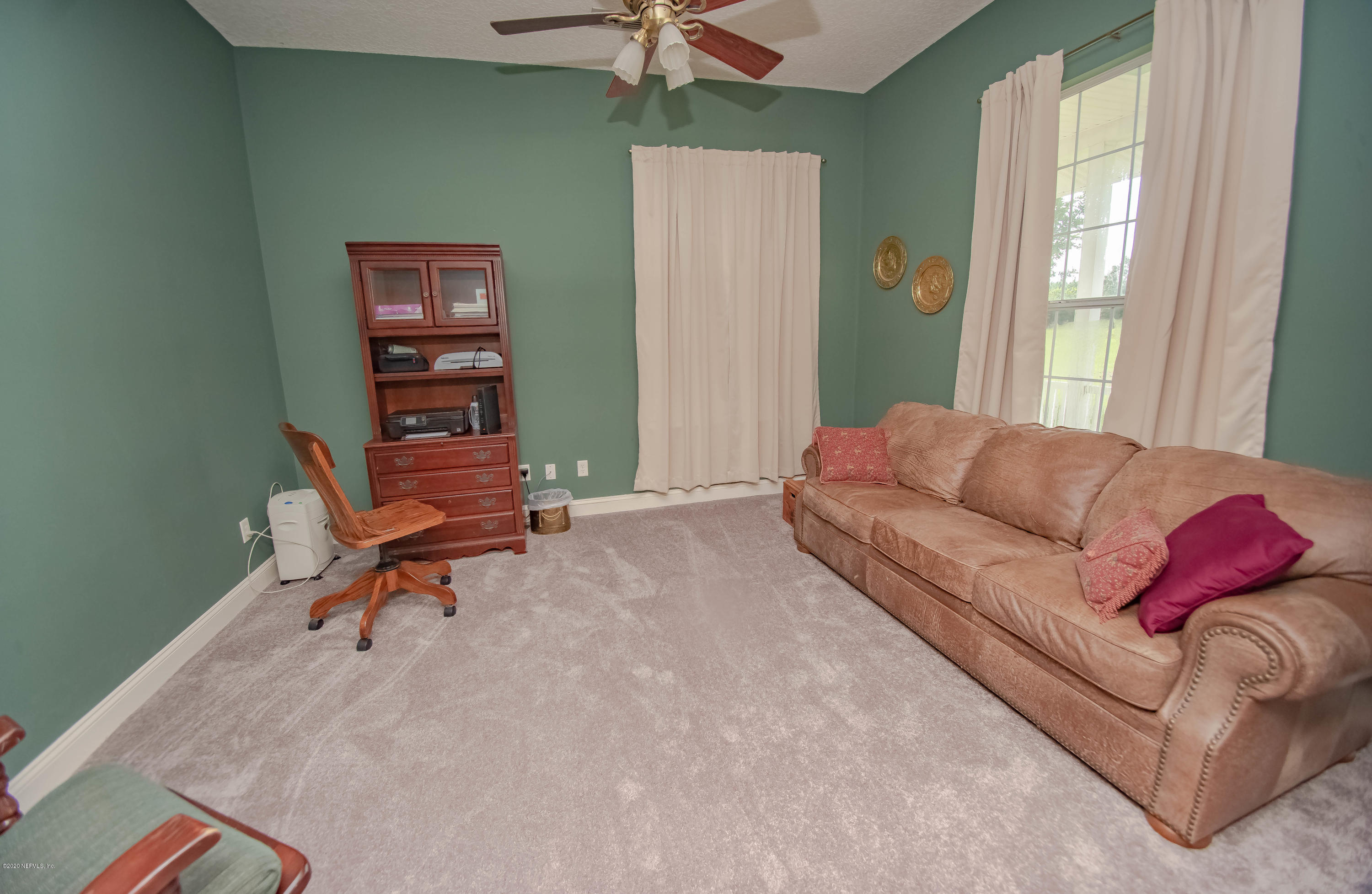 8219 Mud Lake Road Macclenny, FL 32063 - Photo 22 of 63 a living room with furniture and a window