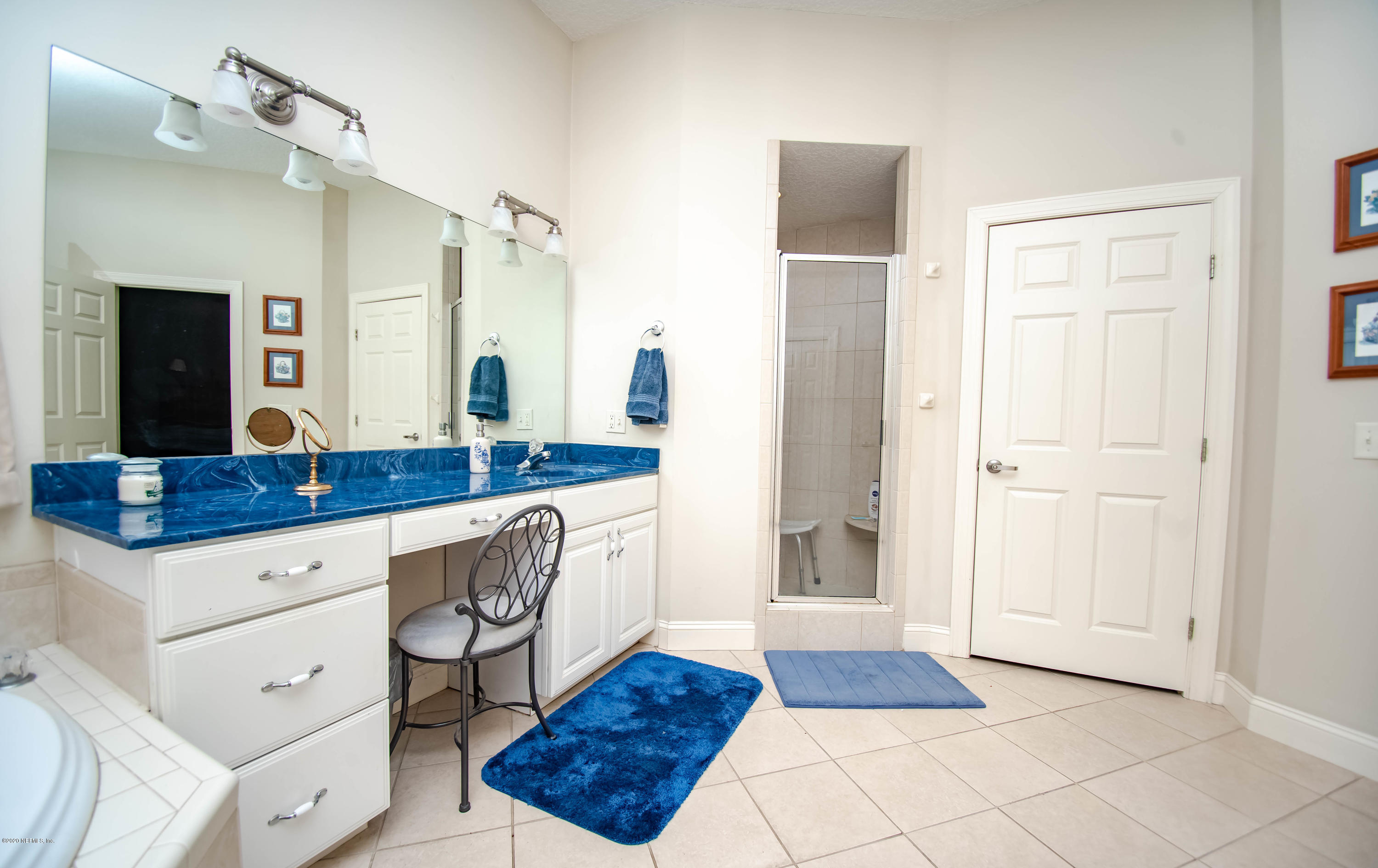 8219 Mud Lake Road Macclenny, FL 32063 - Photo 29 of 63 a spacious bathroom with a granite countertop sink and a mirror