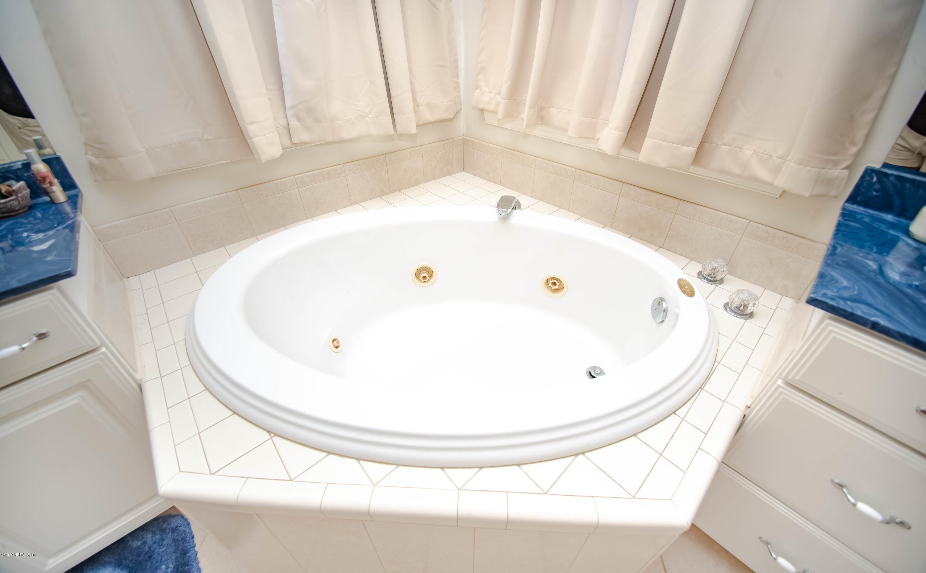 8219 Mud Lake Road Macclenny, FL 32063 - Photo 30 of 63 a bathroom with a bathtub and a window