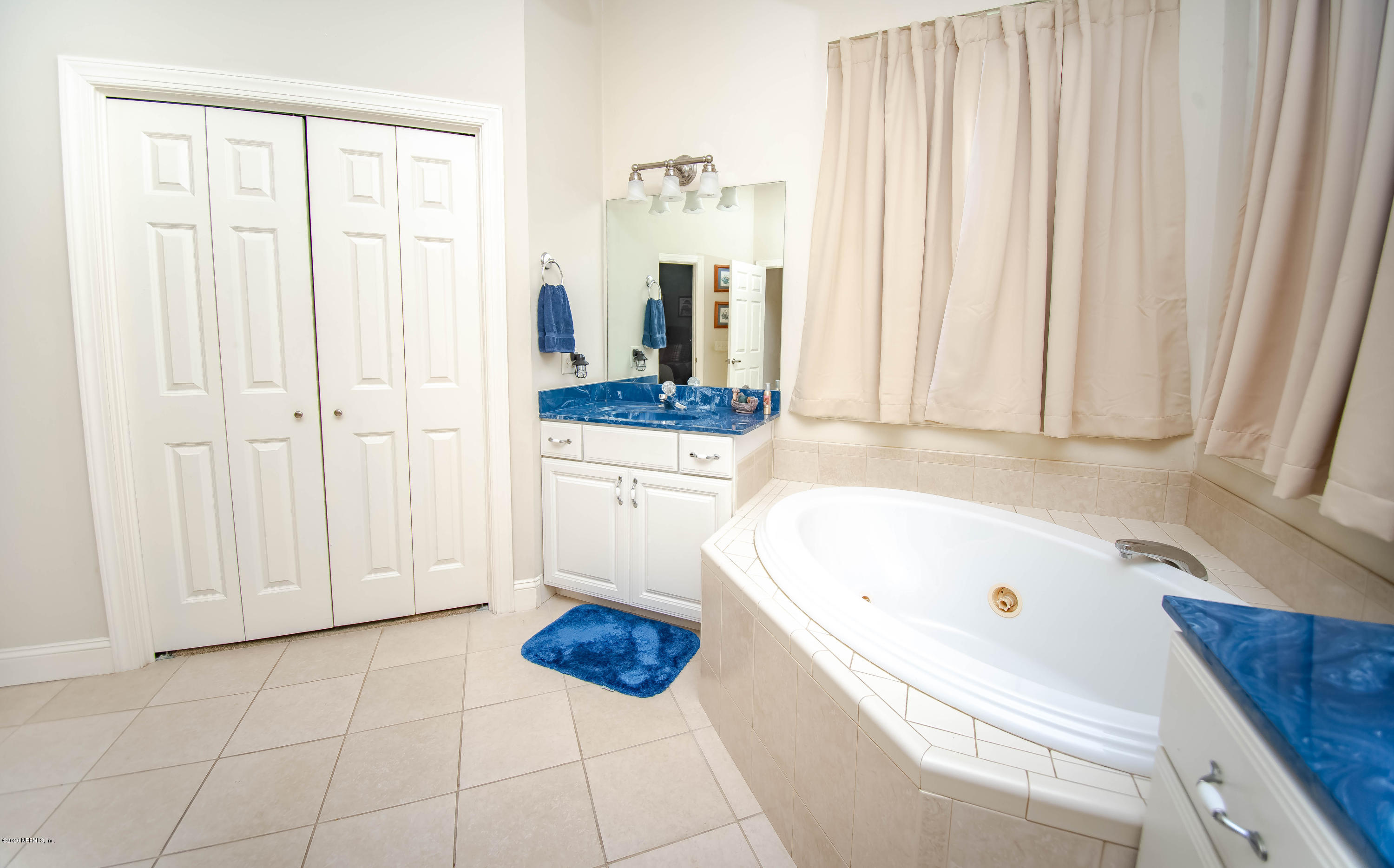 8219 Mud Lake Road Macclenny, FL 32063 - Photo 31 of 63 a bathroom with a tub sink and window
