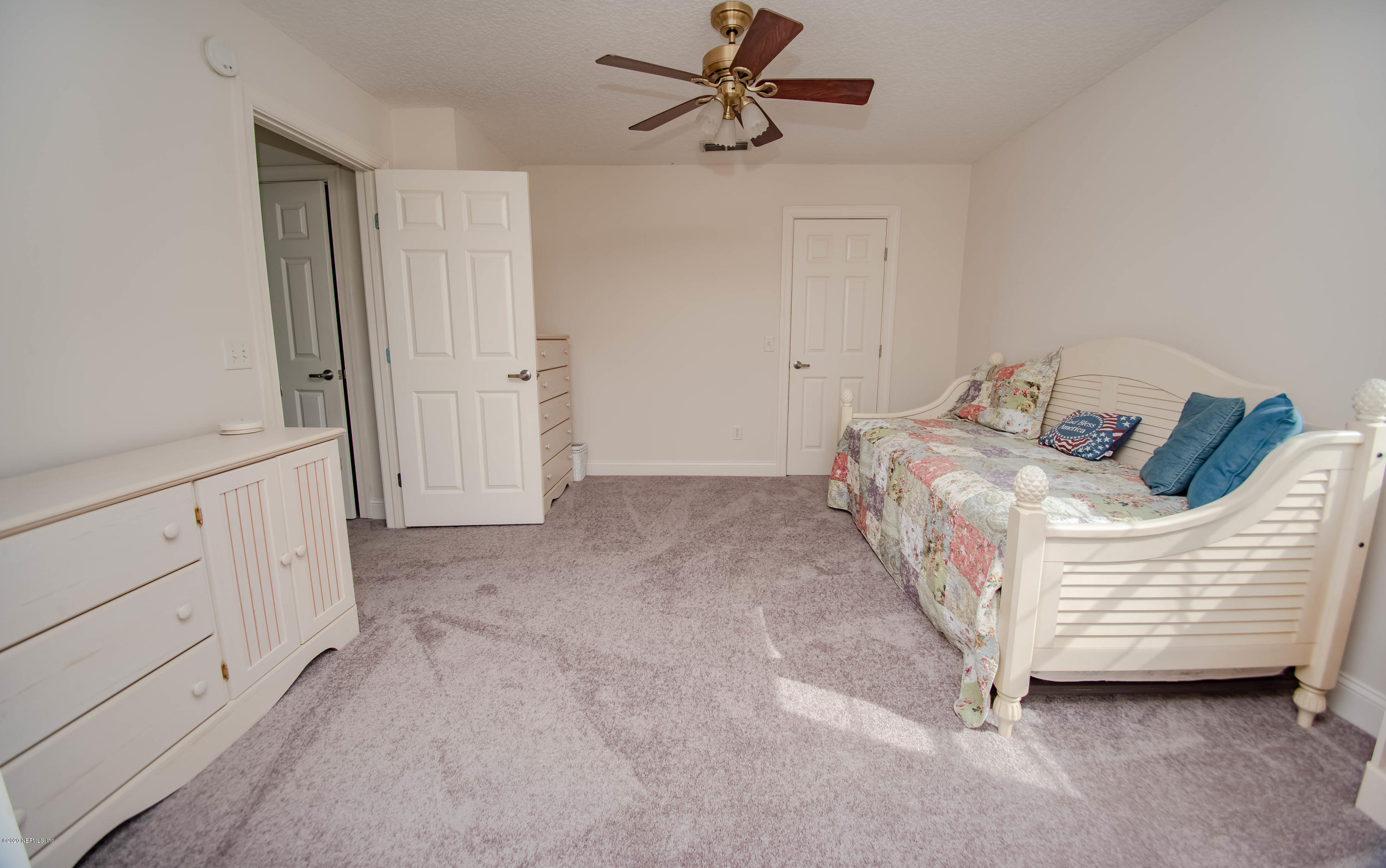 8219 Mud Lake Road Macclenny, FL 32063 - Photo 34 of 63 a bedroom with a bed a dresser and a window