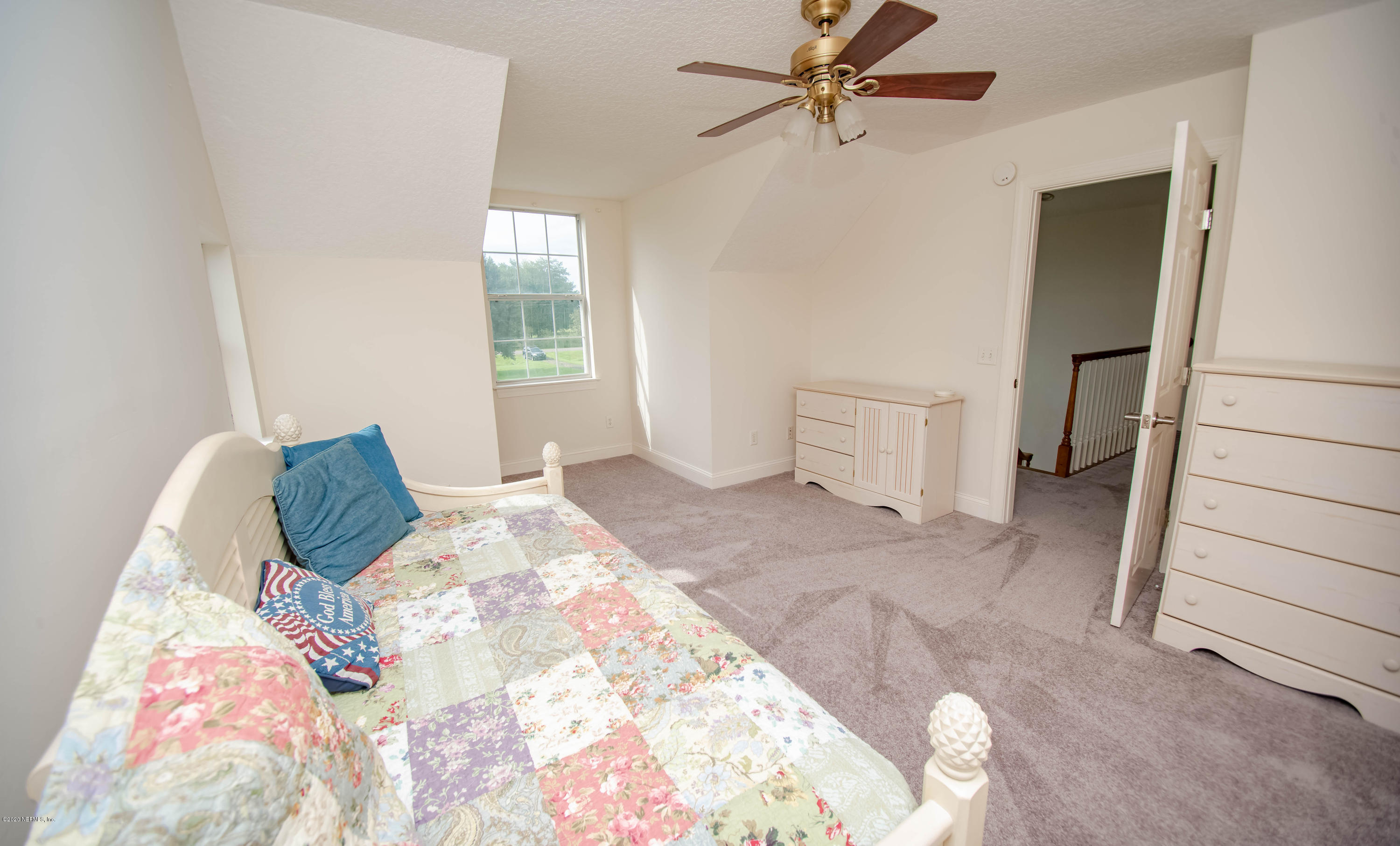 8219 Mud Lake Road Macclenny, FL 32063 - Photo 36 of 63 a bedroom with a bed and window