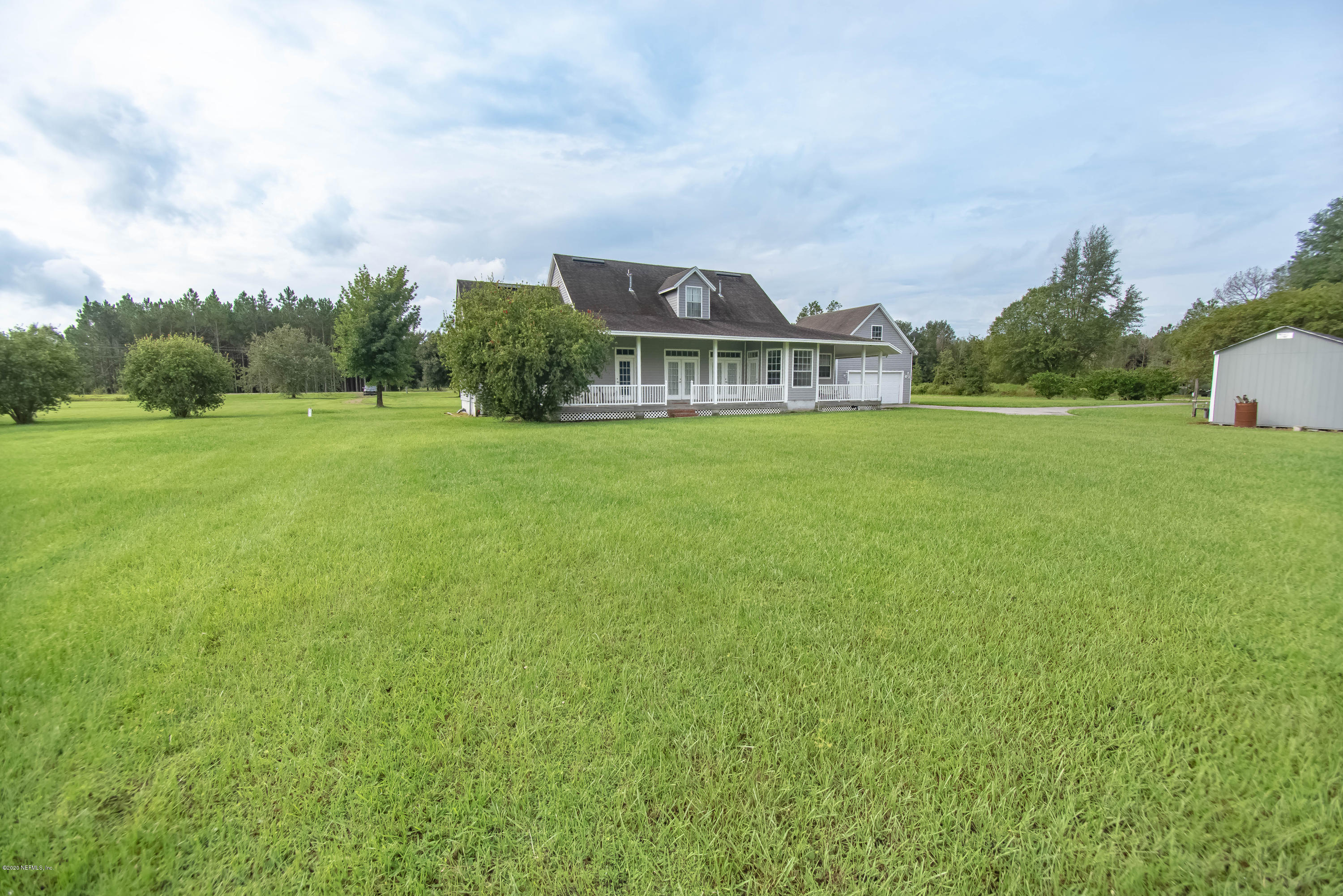 8219 Mud Lake Road Macclenny, FL 32063 - Photo 47 of 63 a front view of a house with a garden
