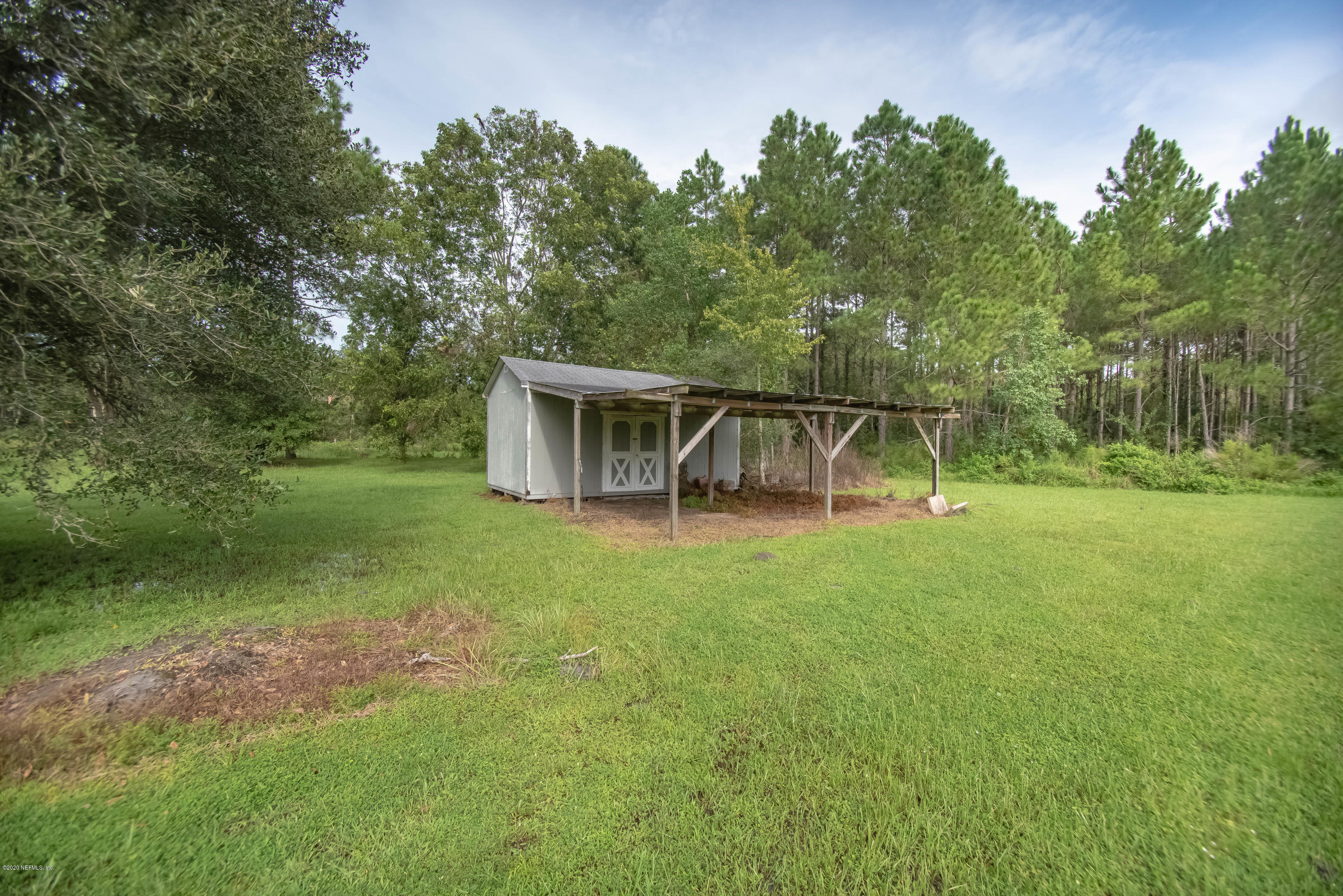 8219 Mud Lake Road Macclenny, FL 32063 - Photo 50 of 63 a view of a house with backyard