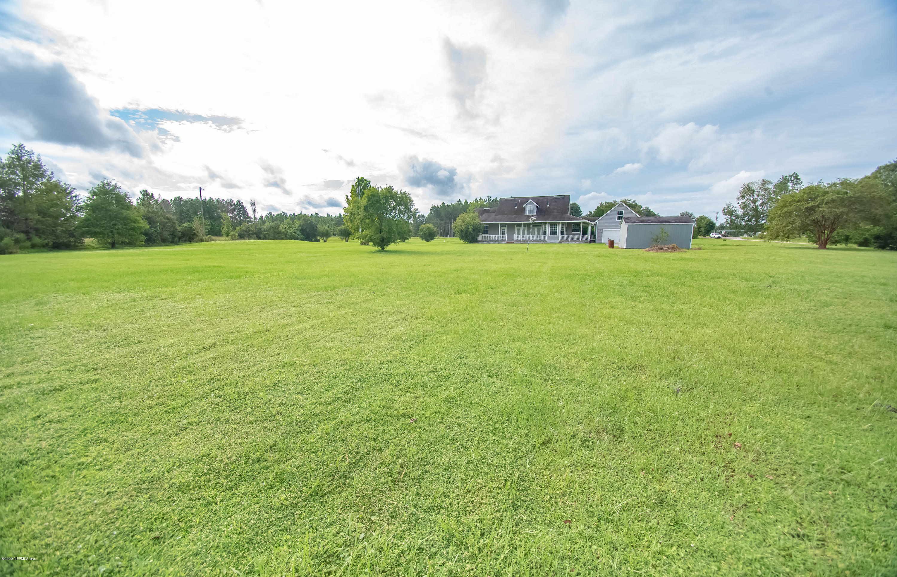 8219 Mud Lake Road Macclenny, FL 32063 - Photo 52 of 63 a view of a field with plants and trees