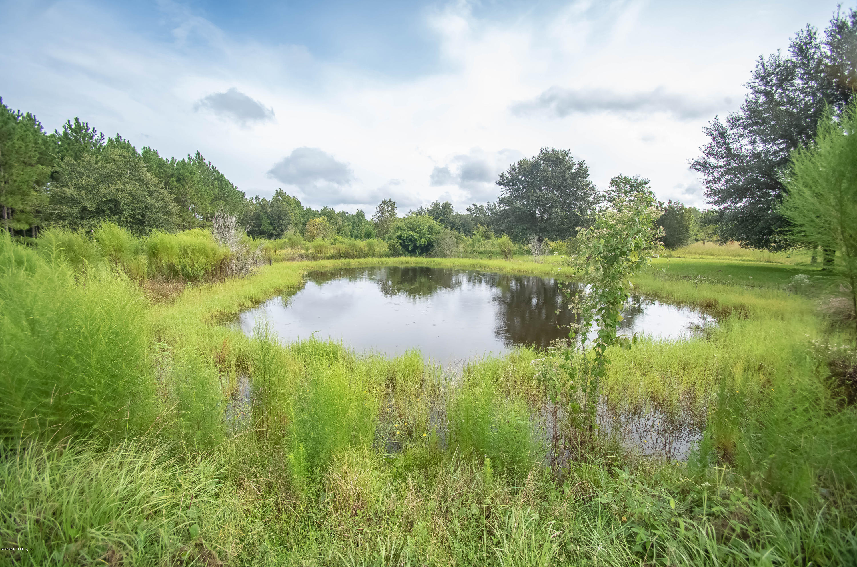 8219 Mud Lake Road Macclenny, FL 32063 - Photo 54 of 63 a view of a lake with houses in the back