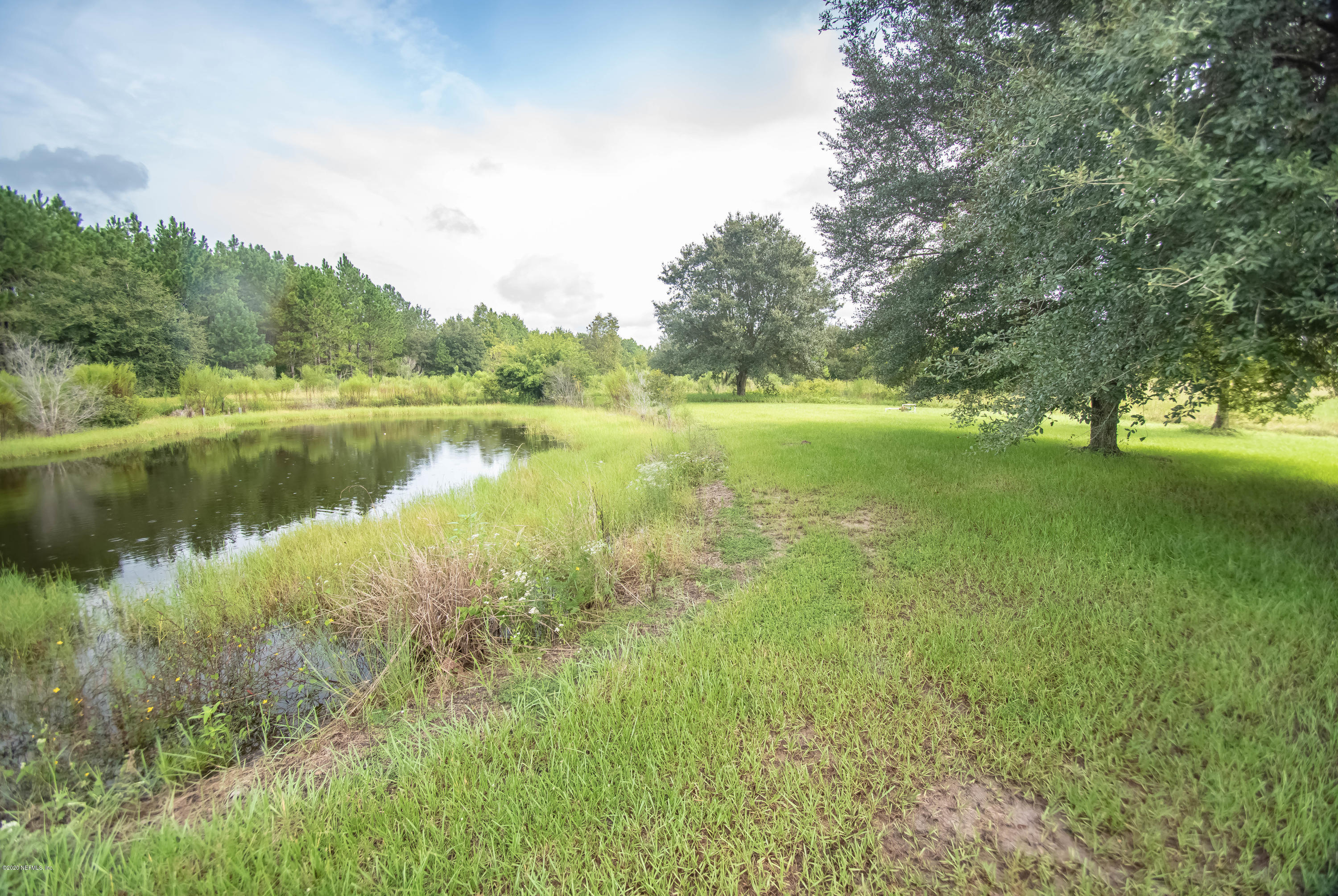 8219 Mud Lake Road Macclenny, FL 32063 - Photo 55 of 63 a view of a lake with houses in the back