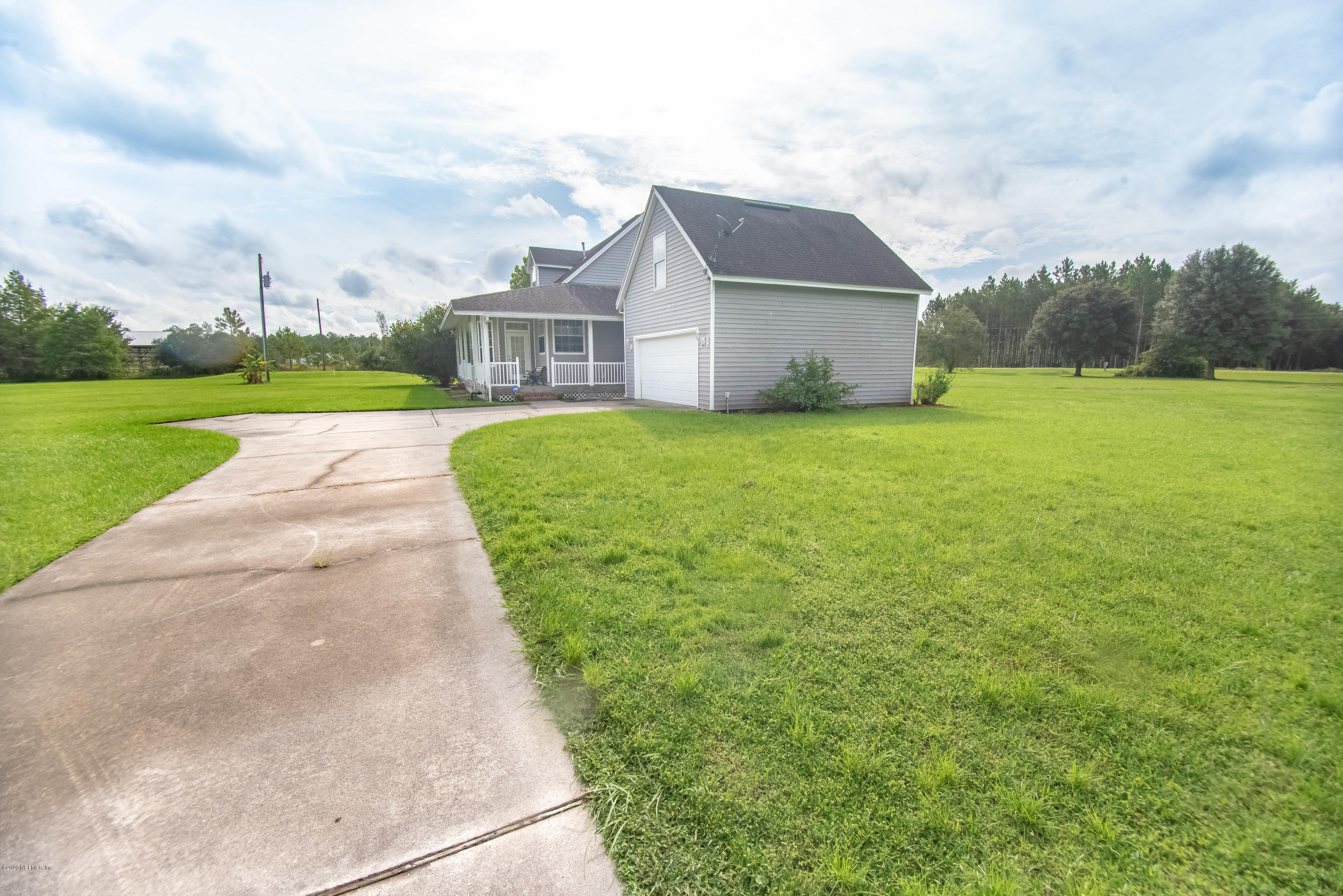 8219 Mud Lake Road Macclenny, FL 32063 - Photo 57 of 63 a view of a house with a big yard plants and large trees