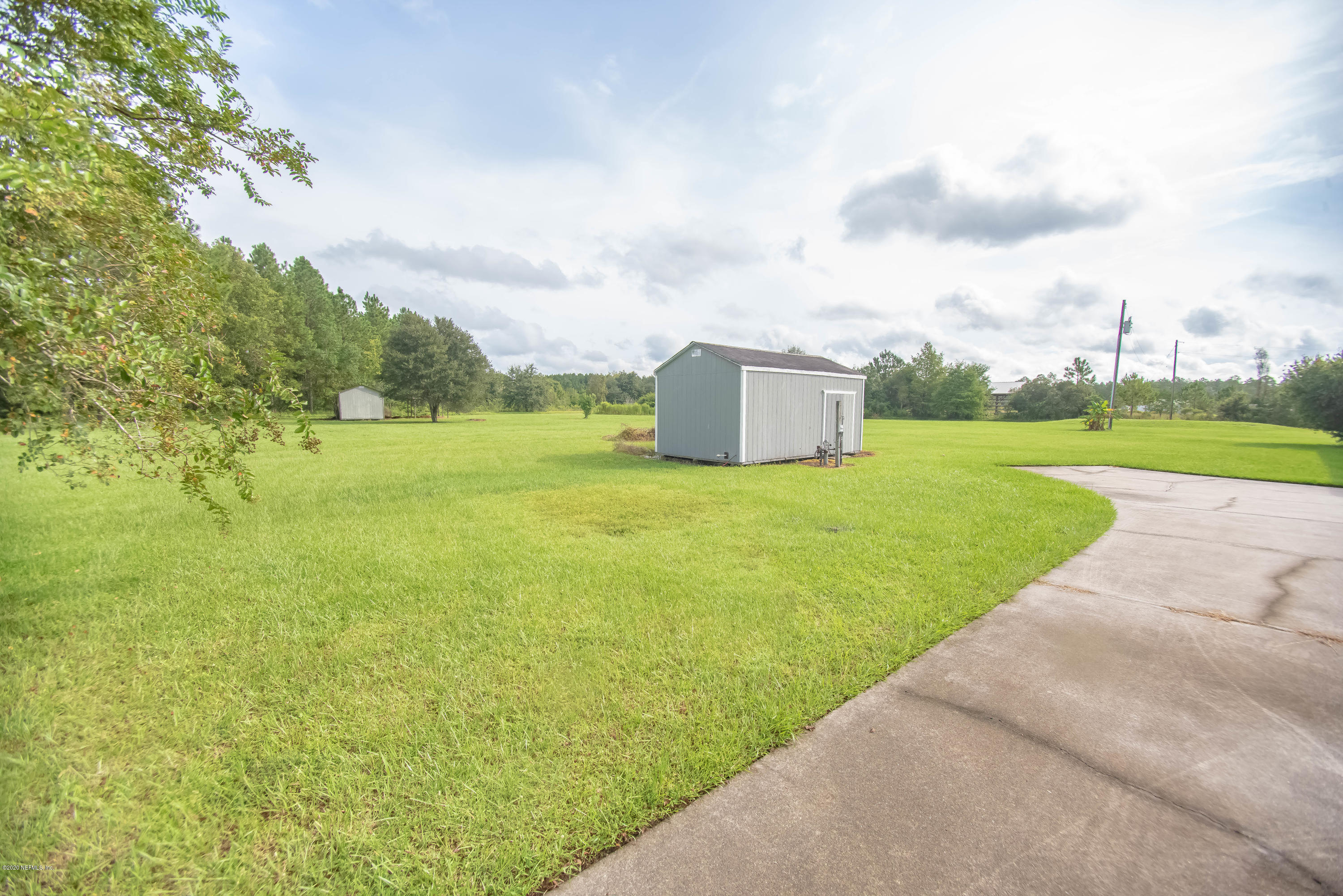 8219 Mud Lake Road Macclenny, FL 32063 - Photo 58 of 63 a view of a big yard with potted plants and big trees
