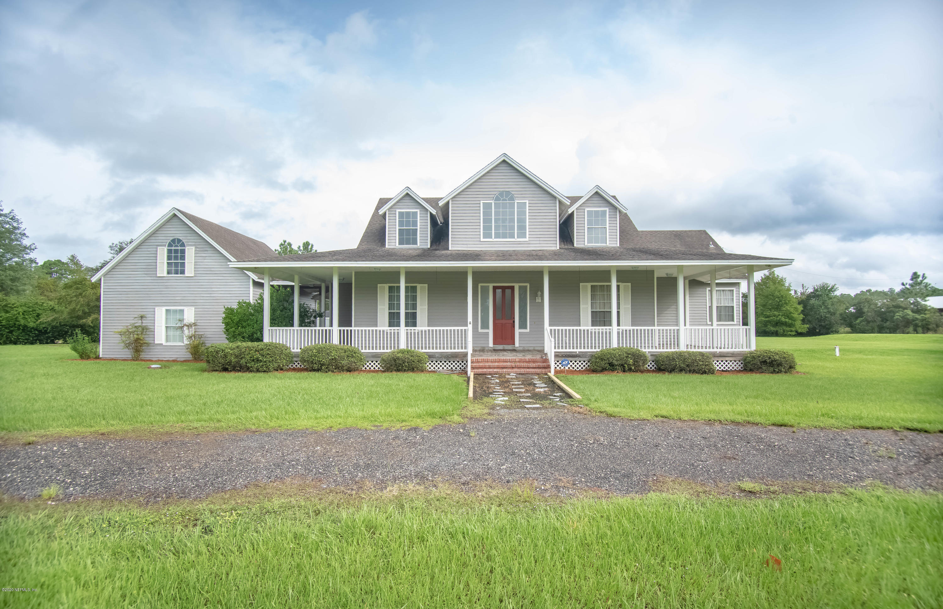 8219 Mud Lake Road Macclenny, FL 32063 - Photo 6 of 63 a front view of a house with a yard and porch