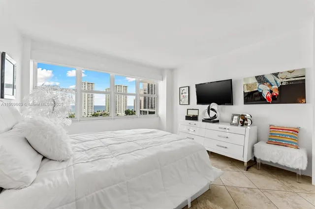 a bedroom with a bed and flat screen tv
