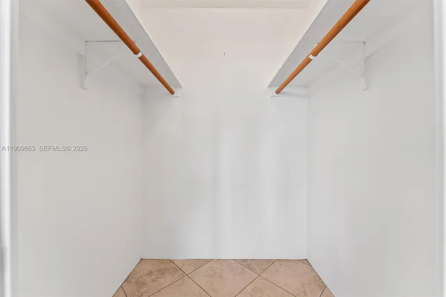 a bedroom with a bed and flat screen tv