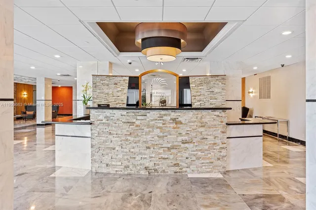 a living room with furniture a fireplace and a chandelier