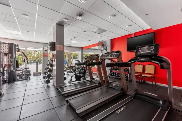 a room with gym equipment and large window