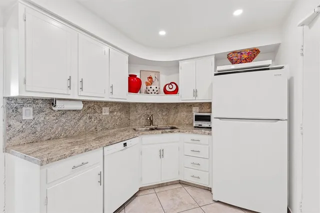 a refrigerator freezer sitting inside of a kitchen