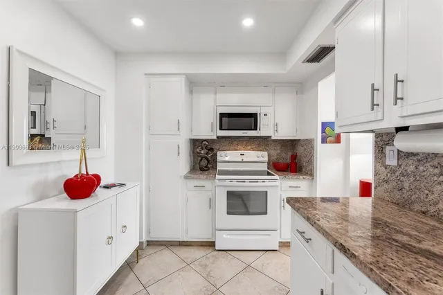 a kitchen with a sink cabinets and appliances