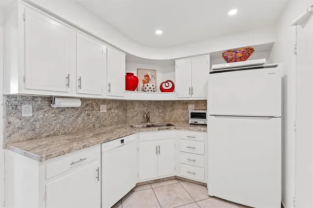 a kitchen with a sink cabinets and appliances