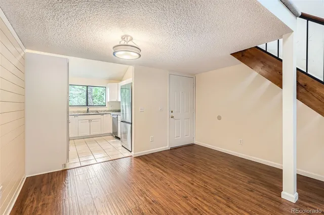 a view of a room with wooden floor and a window