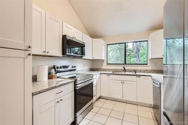 a kitchen with a sink stove and microwave