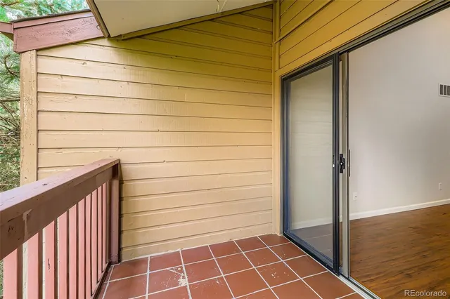 a view of a door and wooden floor