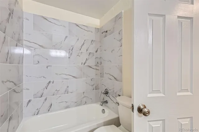 a bathroom with a bathtub and shower