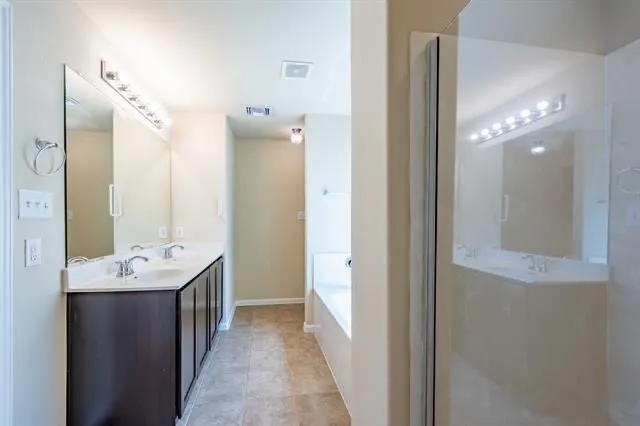 a bathroom with a double vanity sink mirror and shower